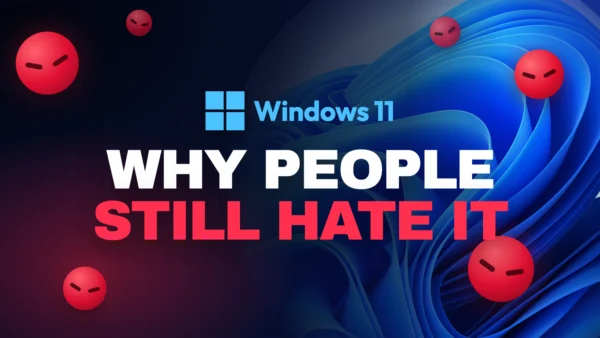 Windows 11 logo on blue wallpaper surrounded by scowling red faces